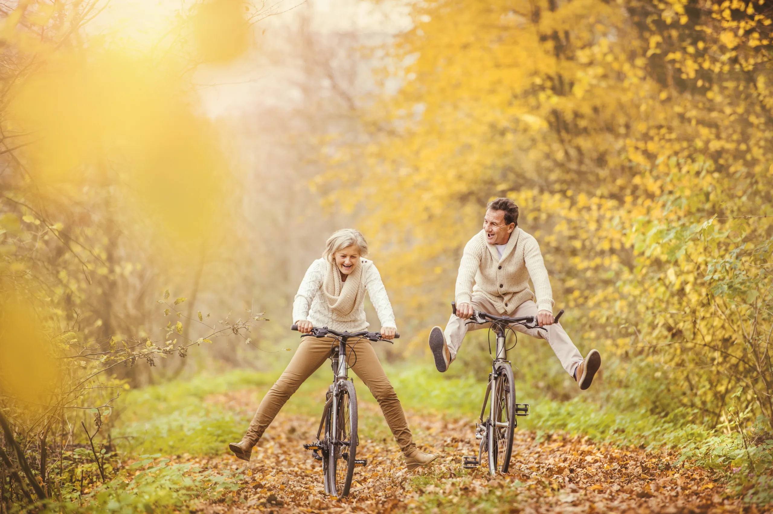 Happy Couple Riding Bicycles in Leafy Park