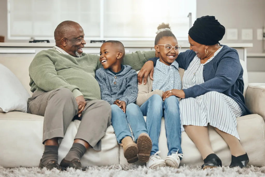 Shot of grandparents bonding with their grandkids on a sofa at home
