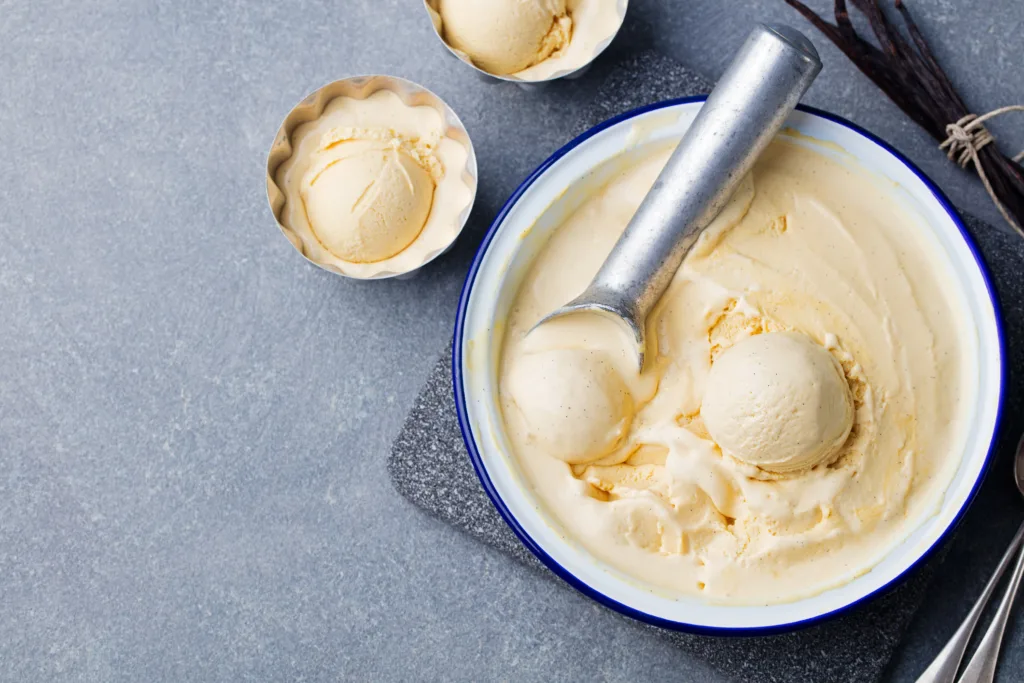 Homemade vanilla, caramel ice cream in vintage bowl Organic product on a grey stone background Top view