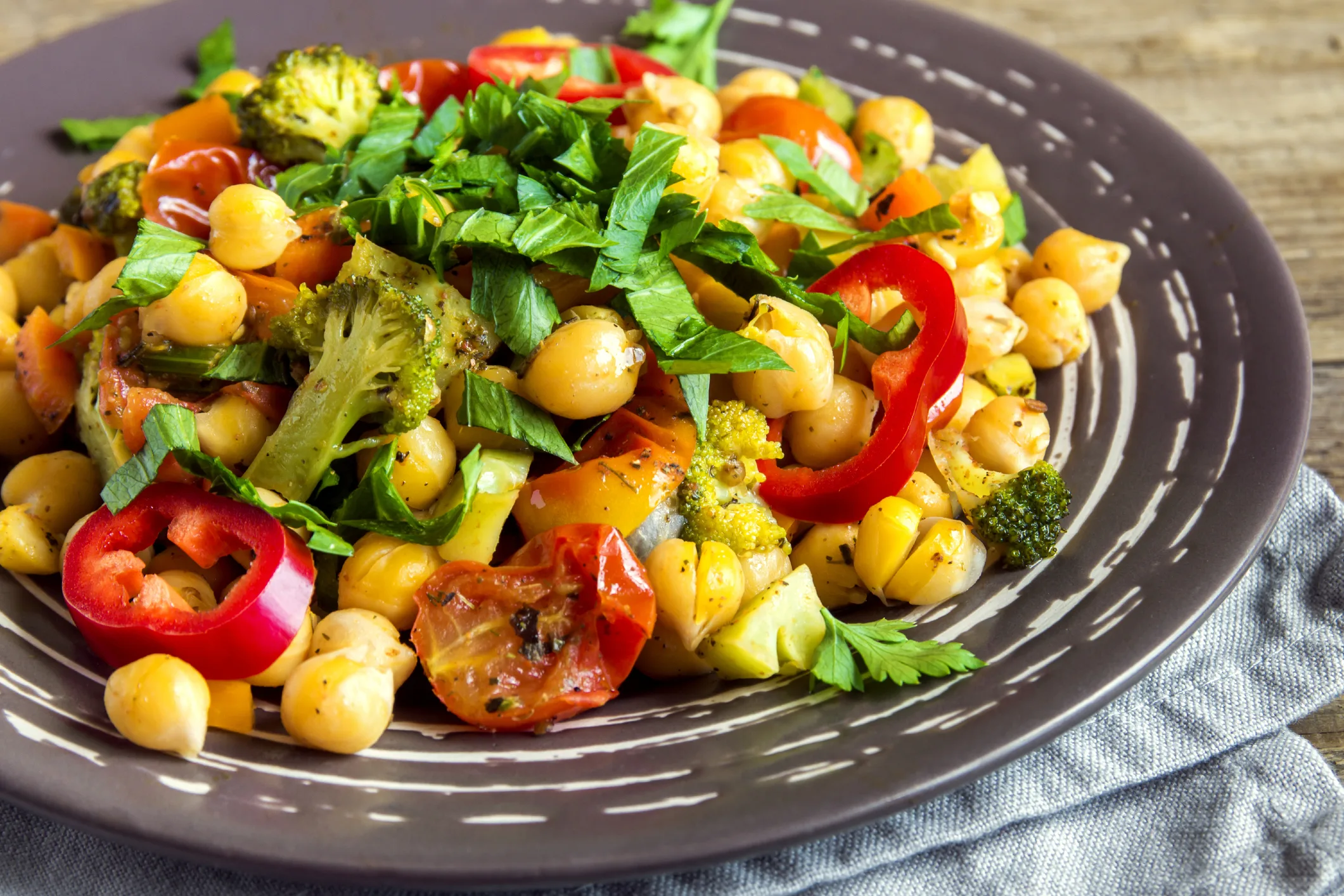 Homemade spicy vegetarian stew with chickpeas and vegetables on plate close up - healthy vegetarian food