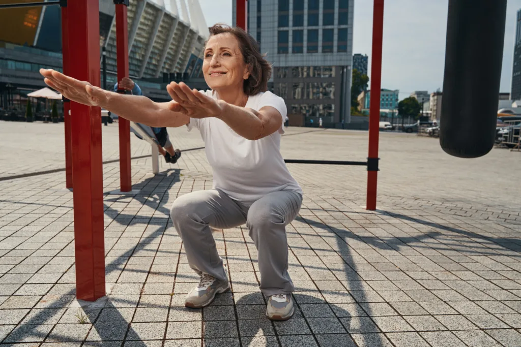 adult fit lady doing squats outdoors