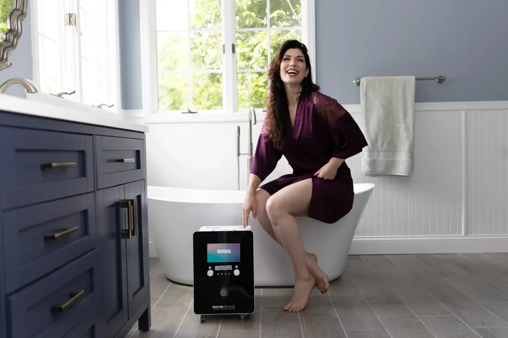 Woman sitting on edge of tube near an echo revive water machine