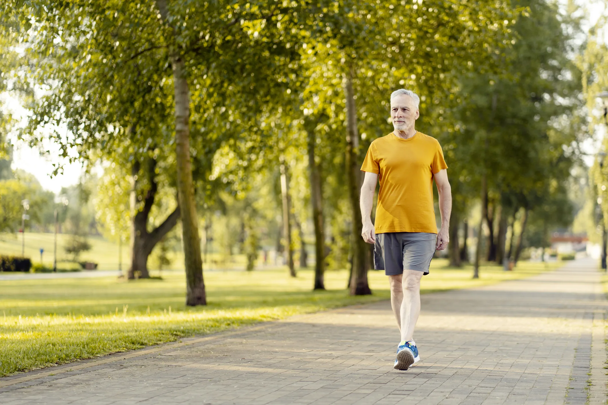 Senior man walking in park enjoying retirement