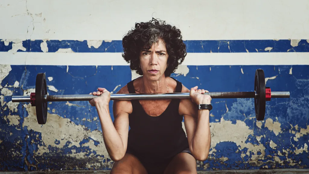 Muscled adult woman exercising in the street