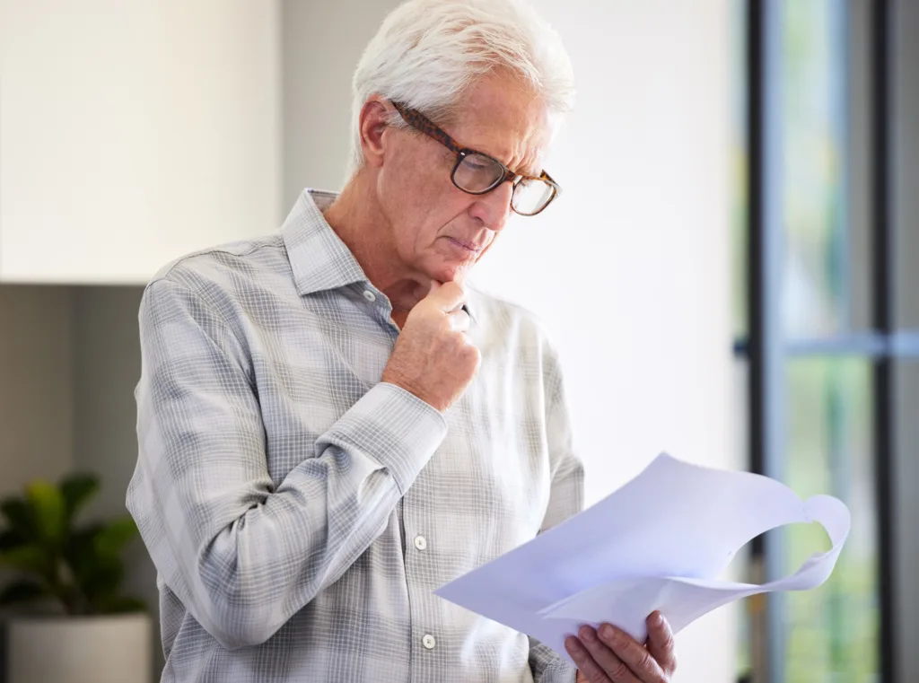 Shot of a mature man reading paperwork