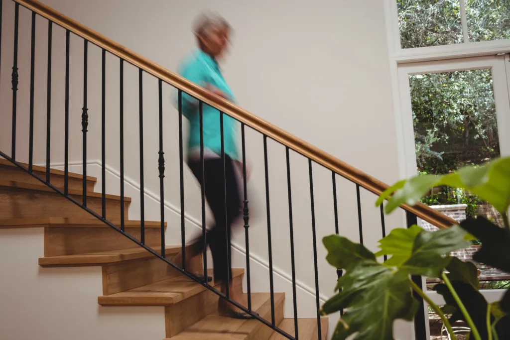 Senior woman walking down stairs