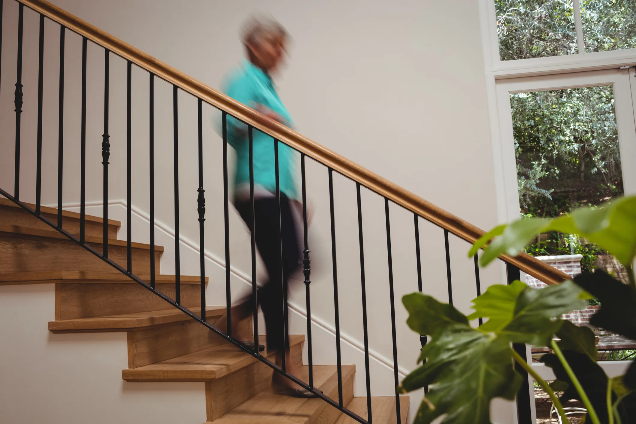 Senior woman walking down stairs