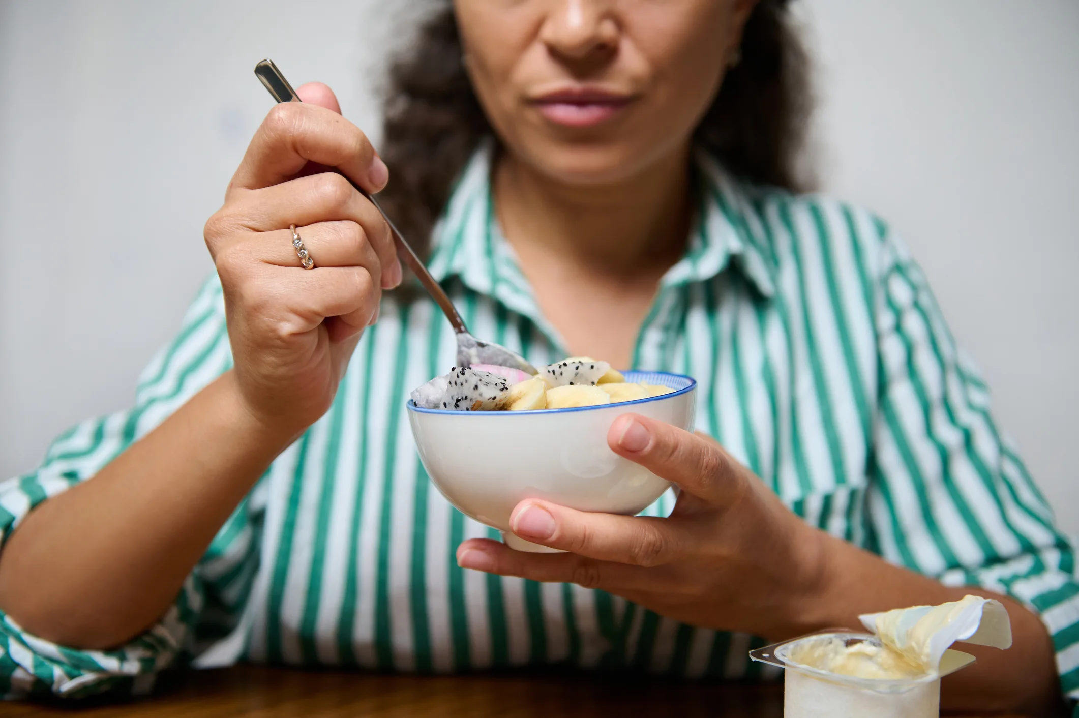 Woman enjoying a healthy fruit dessert at home